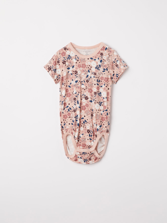 Short-sleeved babygrow in viscose with a floral print