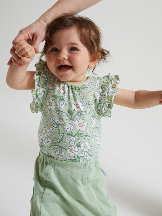 Short-sleeved, white floral babygrow with ruffle