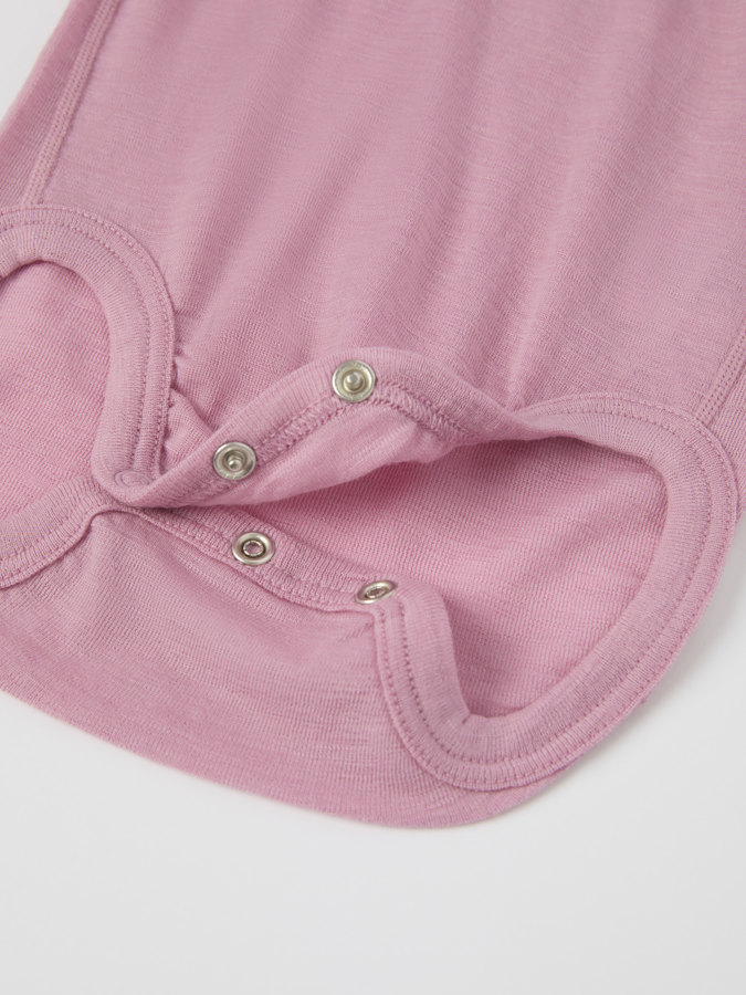 Solid color long-sleeve babygrow in merino wool